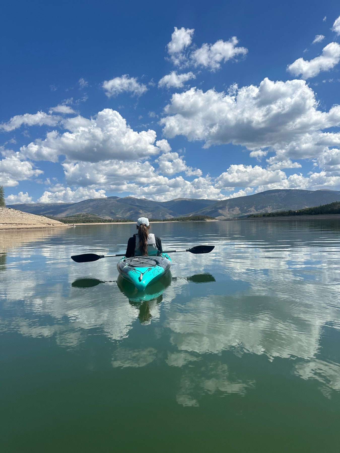 A kayaking scene on a calm Colorado mountain lake
