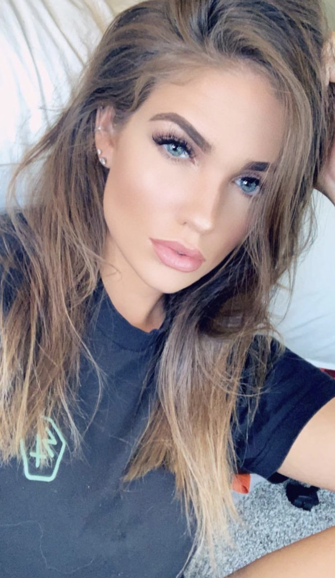 Morgan wearing a black T-shirt with her hair down